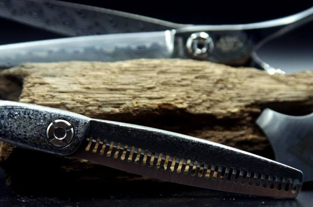 a pair of scissors next to a piece of wood